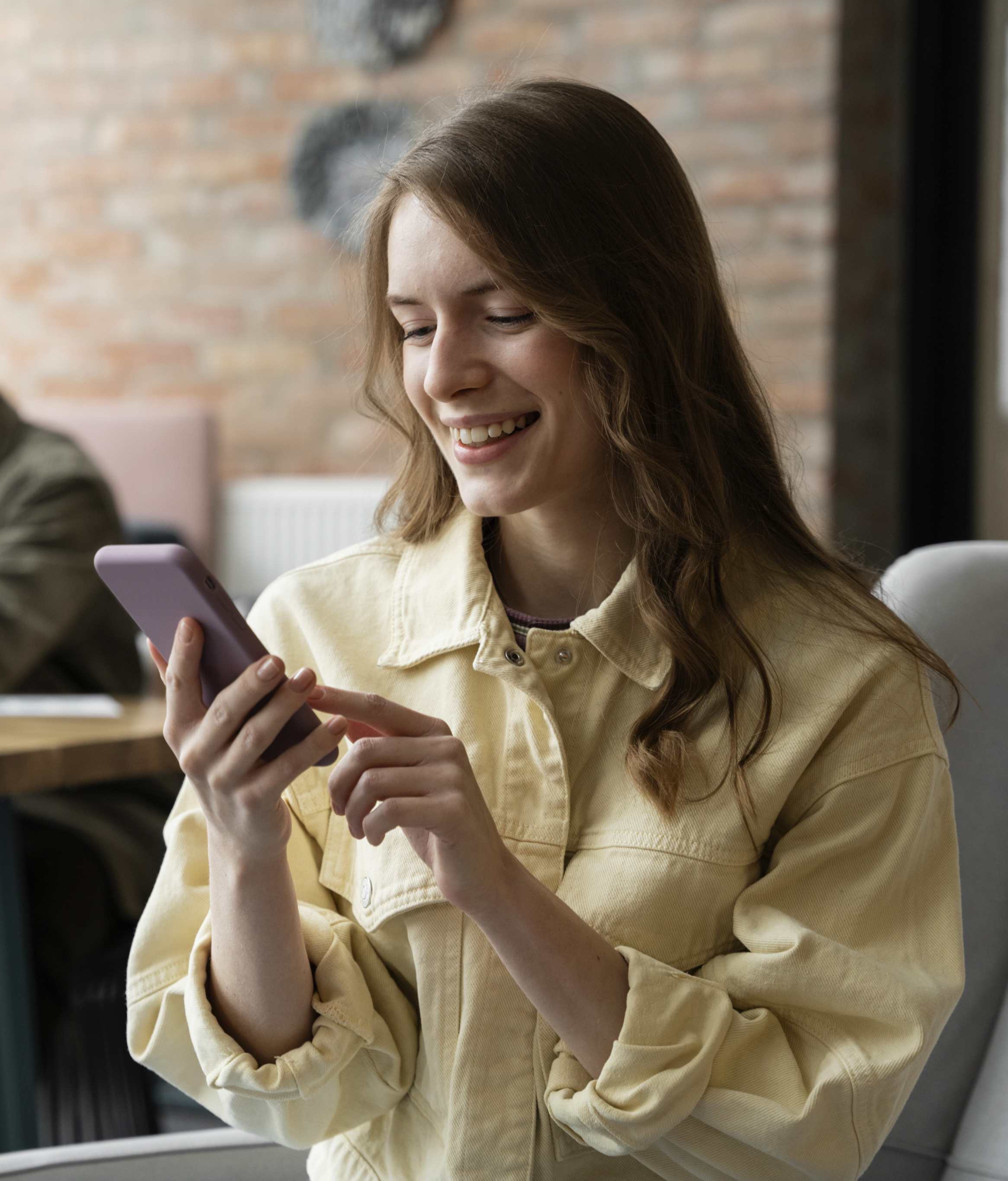 Woman using smartphone for SMS broadcast messaging