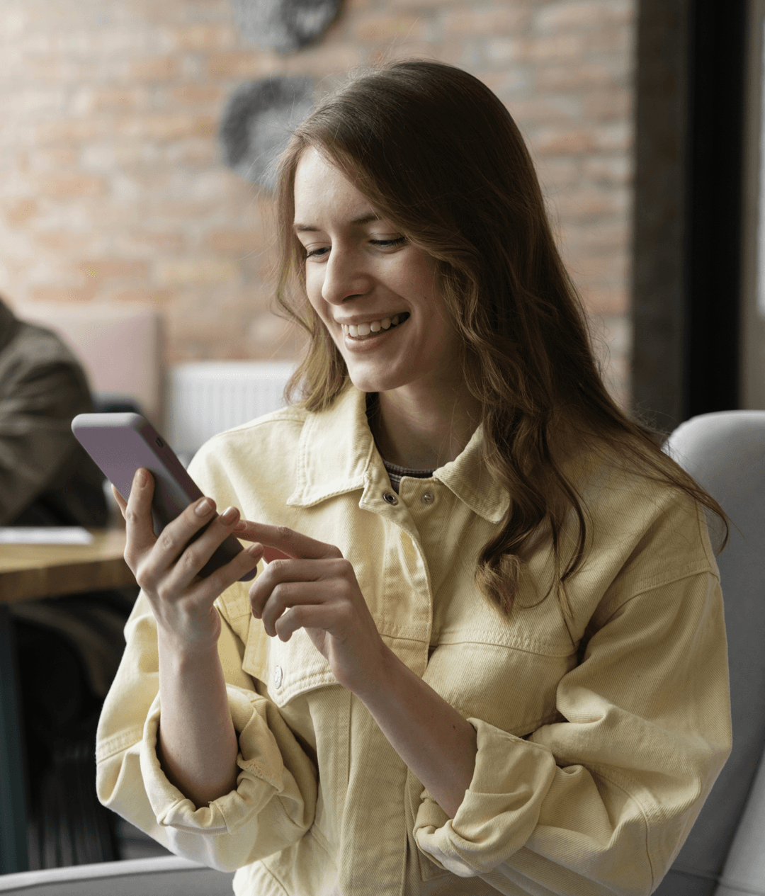 Woman using smartphone for SMS broadcast messaging
